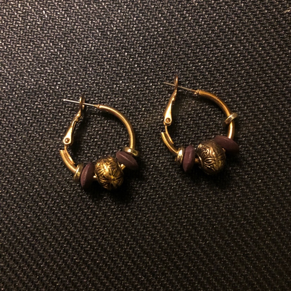 Lightweight circle gold lever back earrings with purple and gold gems.